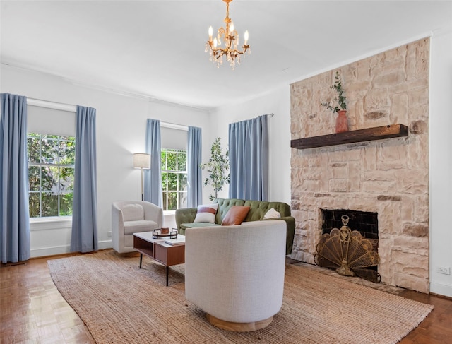 living room featuring parquet floors, a fireplace, and an inviting chandelier