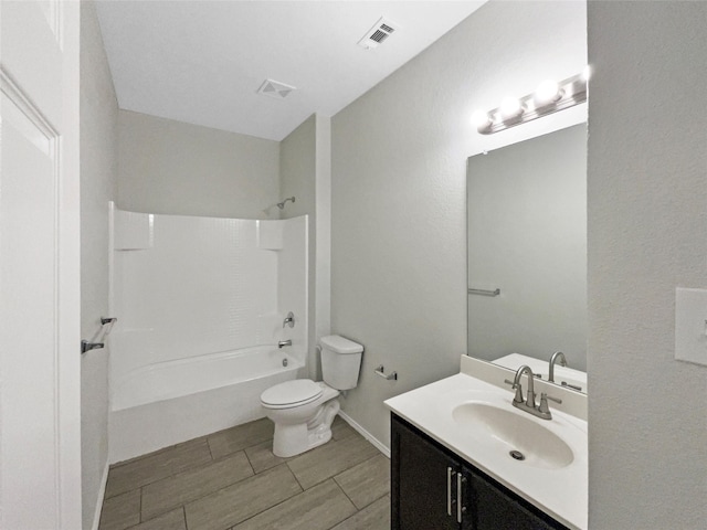 full bathroom with vanity, tub / shower combination, and toilet