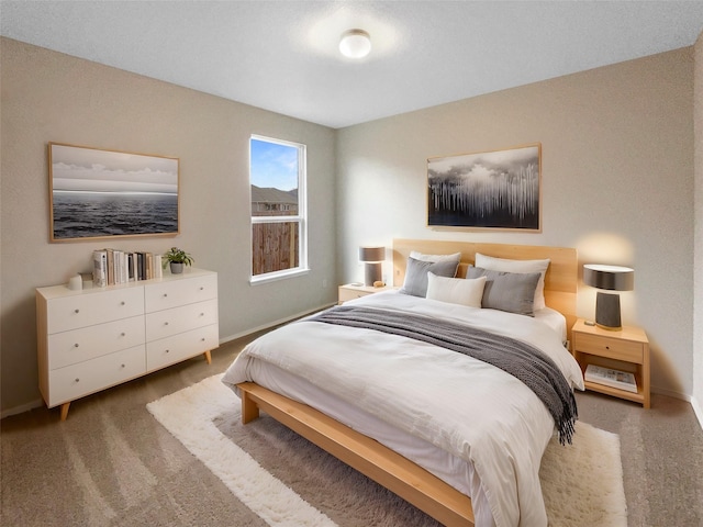 bedroom with dark colored carpet