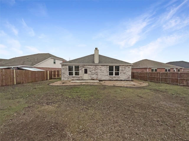 back of property with a lawn and a patio area