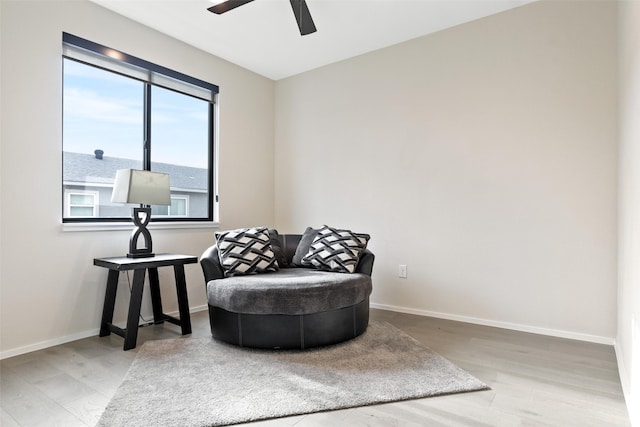 sitting room with ceiling fan and light hardwood / wood-style floors