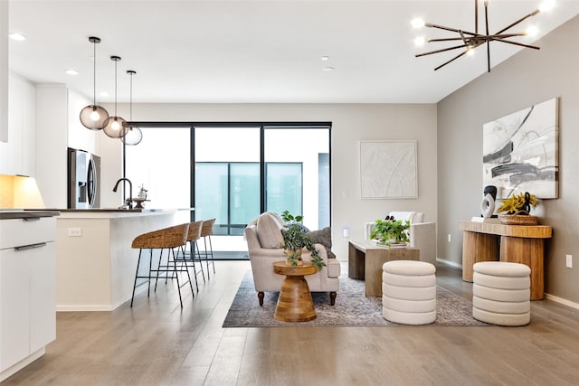 living room featuring an inviting chandelier and light hardwood / wood-style flooring