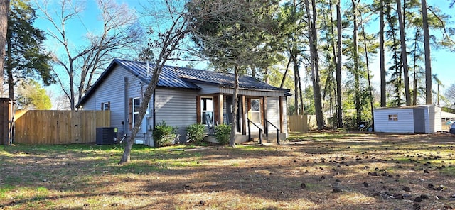 bungalow featuring cooling unit and a storage unit