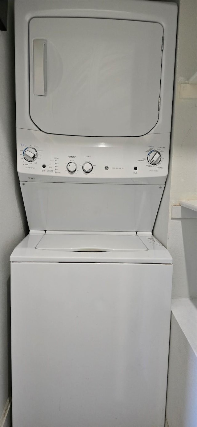 laundry area with stacked washer / dryer