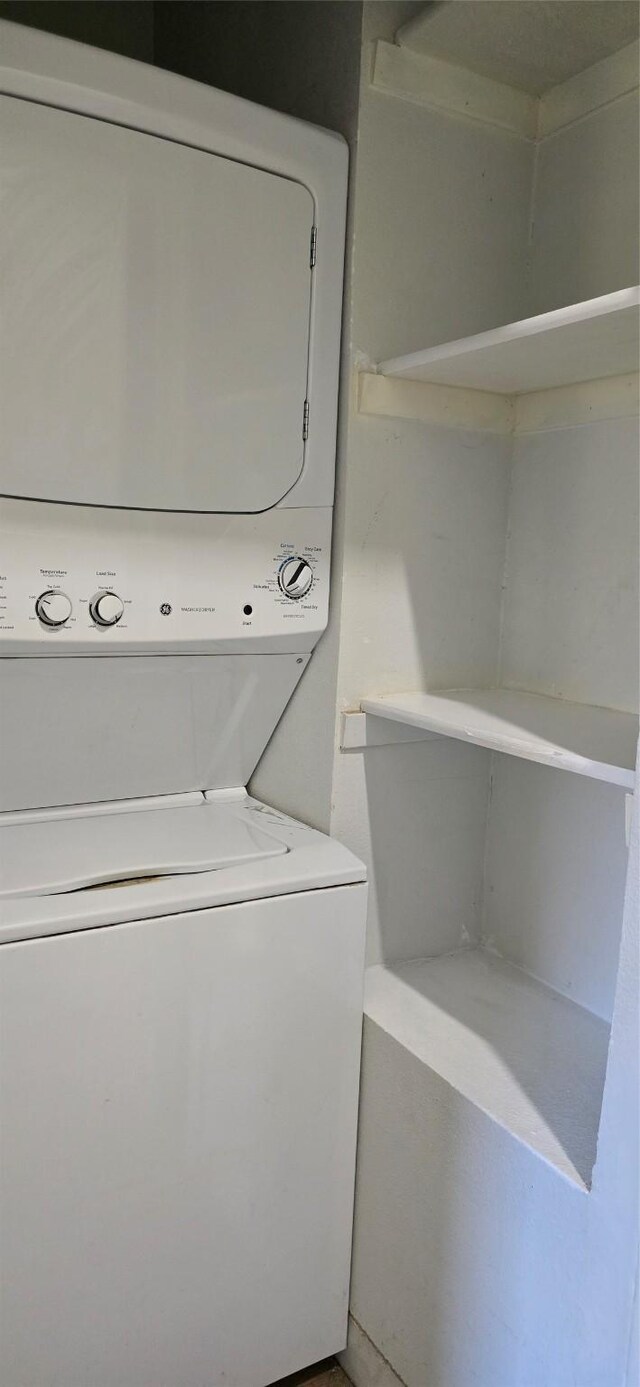 laundry room featuring stacked washer and clothes dryer