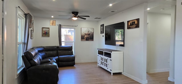 living room featuring ceiling fan and light wood-type flooring