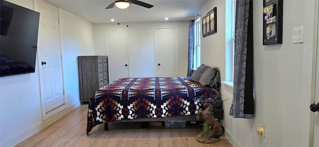 bedroom with ceiling fan and light hardwood / wood-style floors