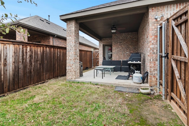 view of yard with ceiling fan and a patio area