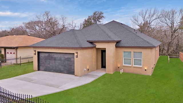 view of front of home featuring a garage and a front yard