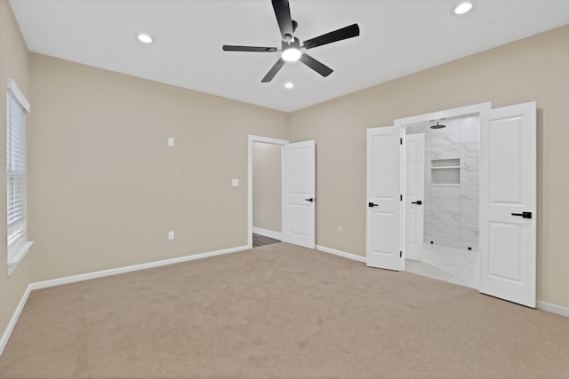 unfurnished bedroom featuring light colored carpet and ceiling fan