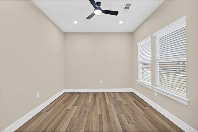 spare room featuring hardwood / wood-style flooring and ceiling fan