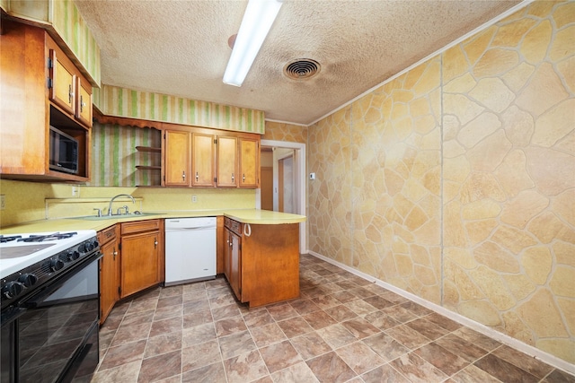 kitchen featuring black gas range oven, sink, white dishwasher, kitchen peninsula, and a textured ceiling