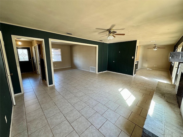 unfurnished living room with light tile patterned flooring and ceiling fan