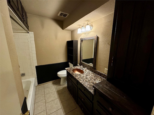 bathroom with vanity, tile patterned floors, and toilet