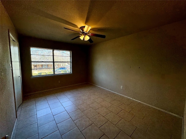 unfurnished room featuring light tile patterned floors, a textured ceiling, and ceiling fan