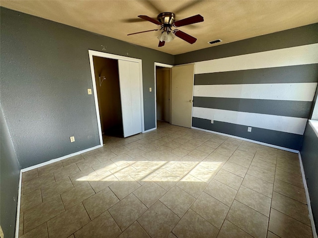 unfurnished bedroom featuring ceiling fan and light tile patterned floors