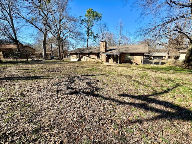 back of property featuring a lawn