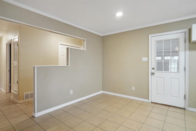 tiled spare room with ornamental molding