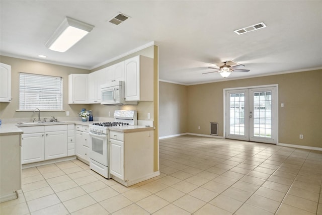 kitchen with sink, white appliances, french doors, and white cabinets