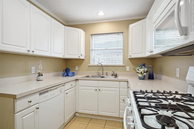 kitchen with sink, white appliances, light tile patterned floors, and white cabinets