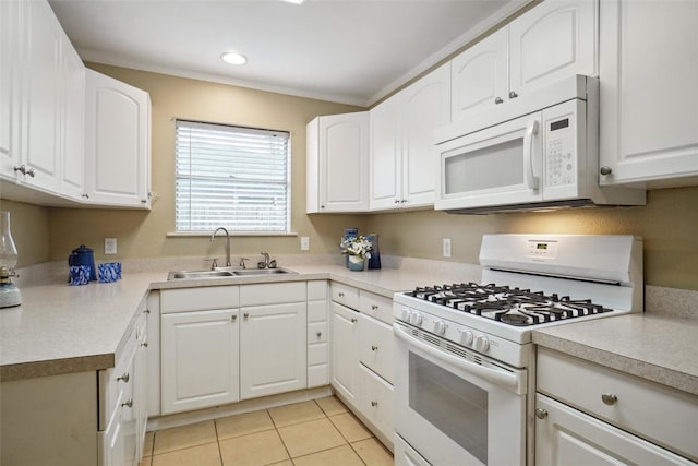 kitchen with white appliances, sink, and white cabinets