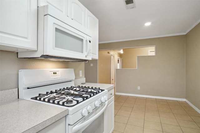 kitchen with light tile patterned floors, white appliances, ornamental molding, and white cabinets