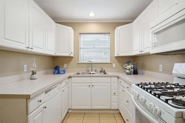 kitchen featuring white cabinetry, sink, light tile patterned floors, and white appliances