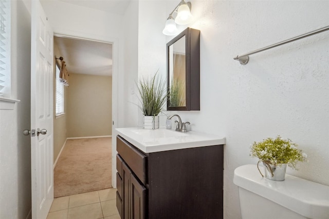 bathroom featuring vanity, tile patterned flooring, and toilet