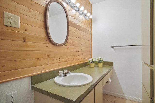 bathroom featuring tile patterned floors, vanity, and wooden walls