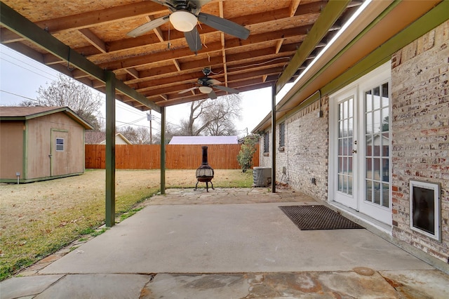 view of patio featuring ceiling fan, a storage unit, central air condition unit, and french doors