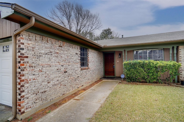 view of exterior entry featuring a lawn