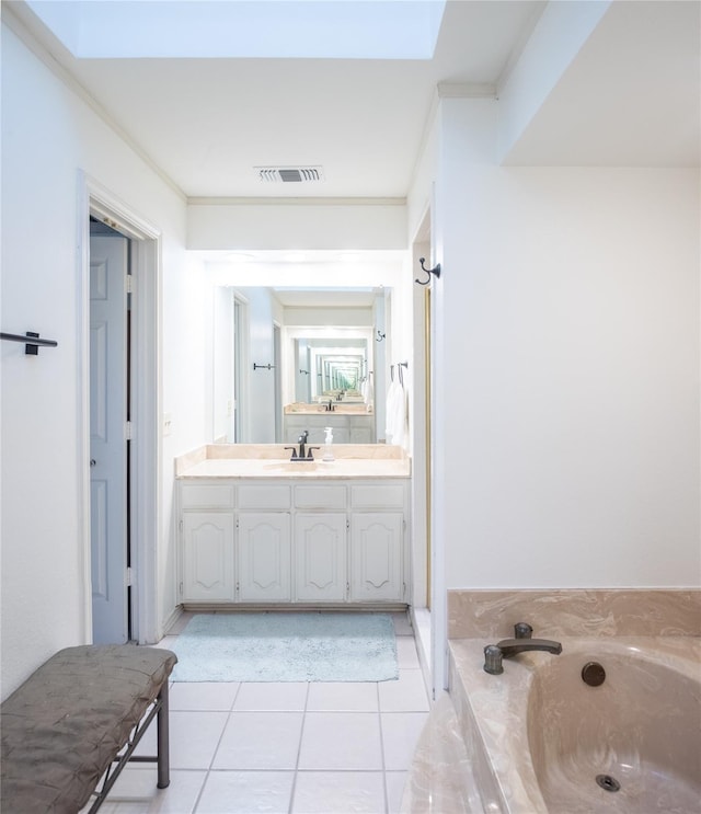 bathroom featuring tile patterned flooring, crown molding, a bath, and vanity