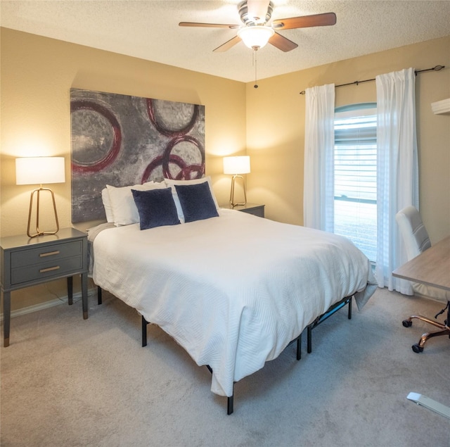 carpeted bedroom with ceiling fan and a textured ceiling