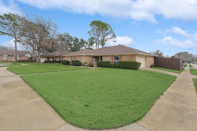 ranch-style home featuring a garage and a front lawn