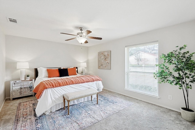 bedroom featuring light colored carpet and ceiling fan