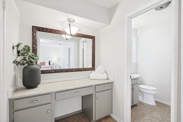 bathroom featuring vanity, tile patterned floors, and toilet