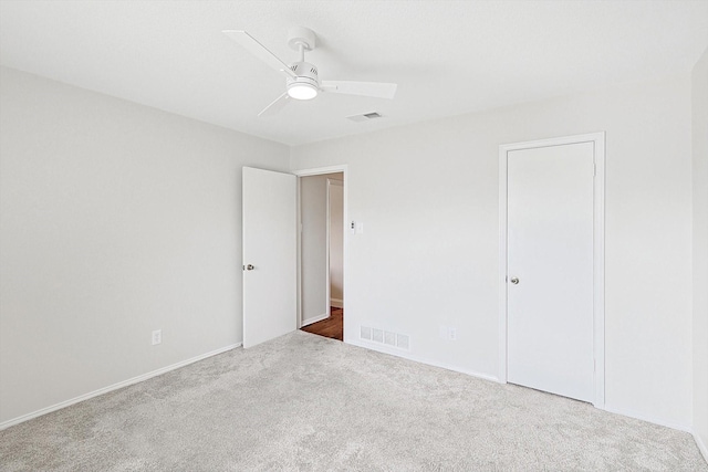 spare room with ceiling fan and carpet floors