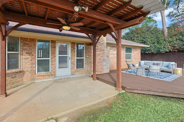 view of patio / terrace featuring a wooden deck, an outdoor hangout area, and ceiling fan