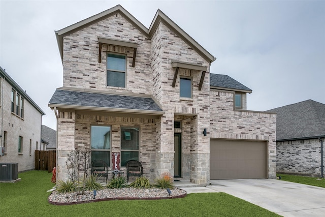 view of front of property with a garage, central AC, and a front lawn