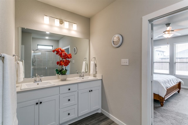 bathroom featuring ceiling fan, a healthy amount of sunlight, an enclosed shower, and vanity