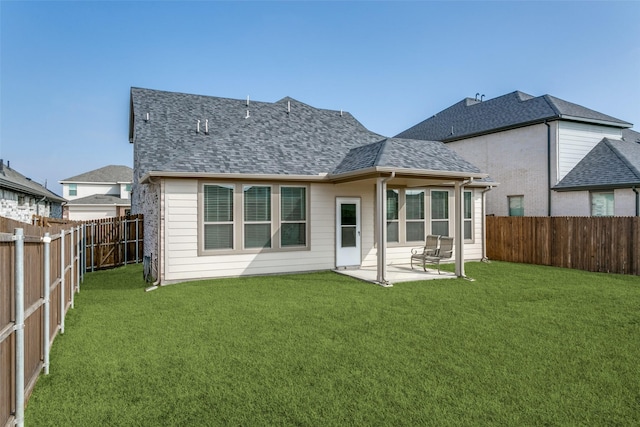 back of property with a lawn and a patio