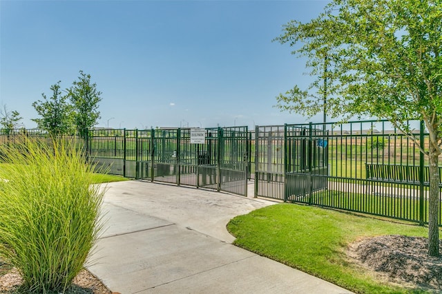 view of gate featuring a lawn