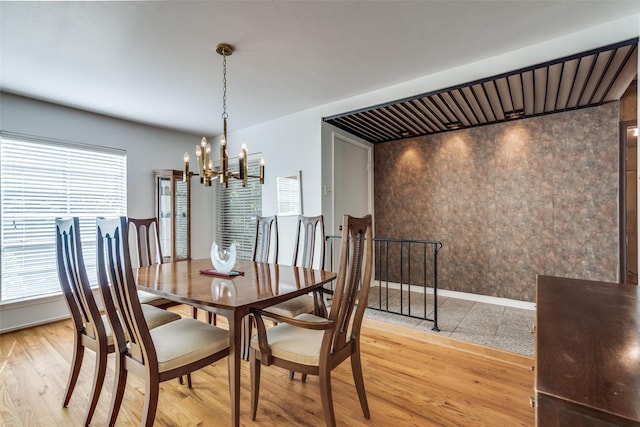 dining area featuring a notable chandelier and light wood-type flooring