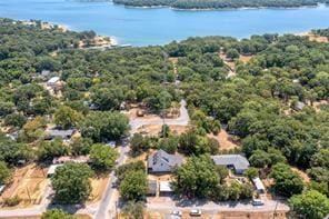 drone / aerial view with a water view and a view of trees