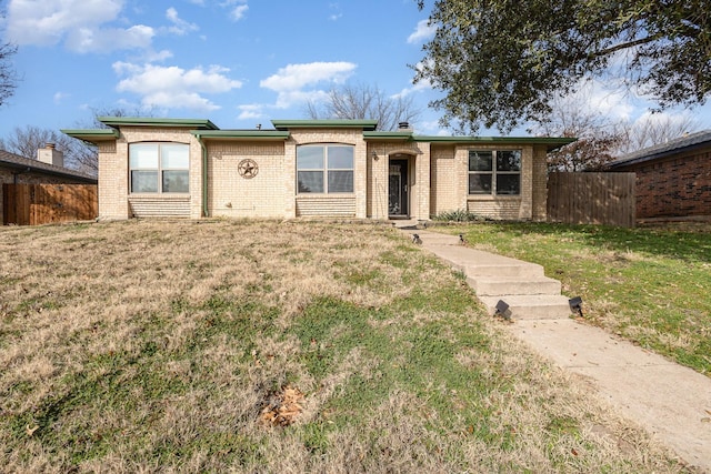 ranch-style home with a front lawn