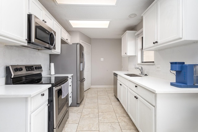 kitchen with white cabinetry, appliances with stainless steel finishes, and sink