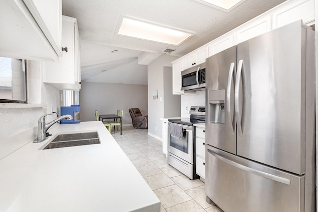 kitchen with white cabinetry, sink, and stainless steel appliances