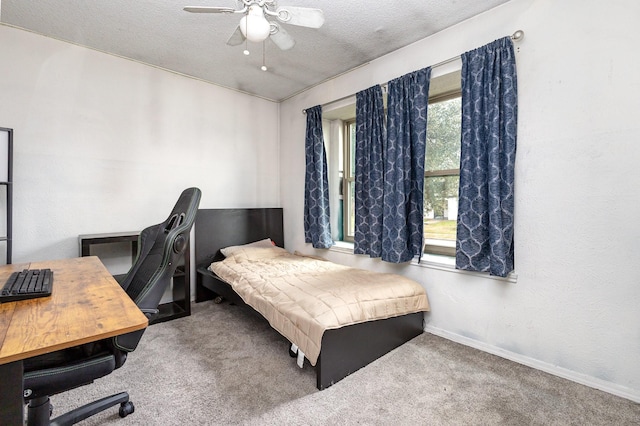 bedroom featuring ceiling fan, carpet floors, and a textured ceiling