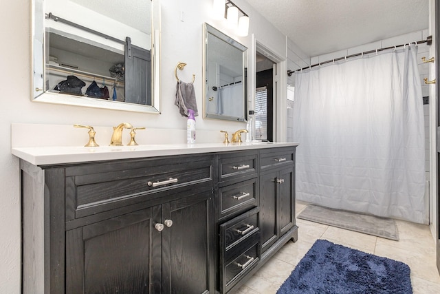 bathroom featuring a shower with shower curtain, vanity, tile patterned flooring, and a textured ceiling