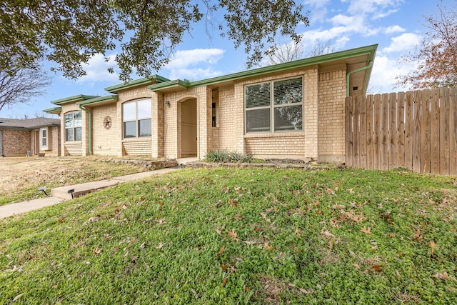 ranch-style home with a front lawn